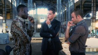 Don Cheadle, Matt Damon and Scott Caan all standing each other with thier hand to their chin deep in thought.