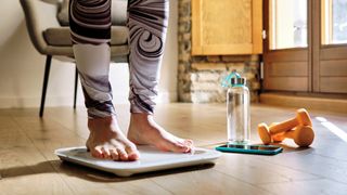 Woman stood on a smart scale at home