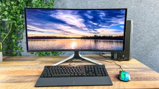 Alienware 34 Curved QD-OLED gaming monitor on a desk showing desktop