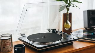 The Audio-Technica AT-LP70xBT in Black Silver on a wooden table