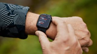 A person monitors their heart rate using an Apple Watch.