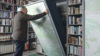 A man folds away his murphy bed