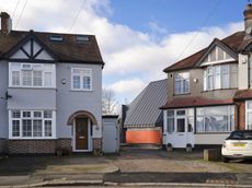 station lodge an unusual london home with a huge grey pitched roof and a red staircase