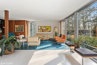 colourful views of michigan's modernist, single storey Frost House with large openings towards nature