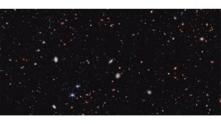 a deep-sky image showing hundreds of distant galaxies