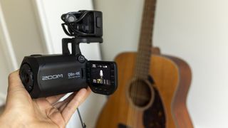 The Zoom Q8n-4K in front of a guitar