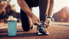 Man tying the laces of a running shoe 