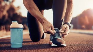 Man tying the laces of a running shoe 