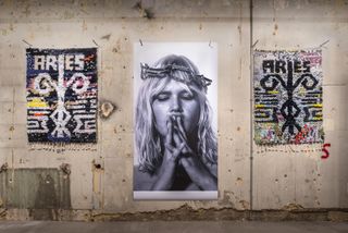 Interior of Aries London store with concrete wall with wall hangings and posters