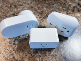 Meross Smart Wifi Plug Mini in front of an Ikea and Sylvania Smart Plug