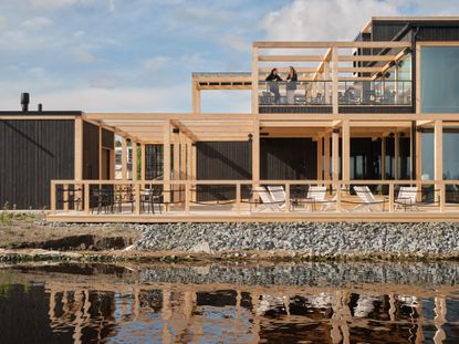 luoto sauna restaurant exterior with waters ourside and grid timber architecture, as an example of contemporary wellness architecture