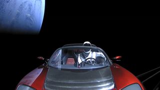 SpaceX's Starman mannequin is seen inside Elon Musk's red Tesla Roadster in space, with the brilliant Earth in frame, in this jaw-dropping view from a camera on the car. SpaceX launched the mannequin and Roadster into space on the first Falcon Heavy test flight on Feb. 6, 2018, then beamed back live views from the car.