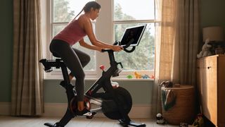 A woman riding a Peloton bike