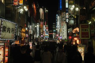 Tokyo street at night with neon signs