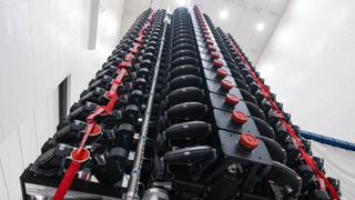 stack of satellites in a tower shown in a warehouse