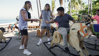 Twins Bailey Smith and Anthony Smith pass a note to a boy on a rocking horse in &quot;The Amazing Race&quot; season 36