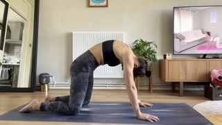 Best yoga mats: Writer Sam performing cat-cow on her yoga mat during Pilates workout