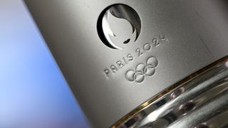 Close up of the Paris 2024 Olympics logo on the metallic Olympic torch.