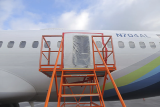 This photo released by the National Transportation Safety Board shows a gaping hole where the paneled-over door had been on an Alaska Airlines Flight in Portland, Oregon.