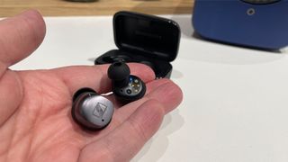 Sennheiser Momentum True Wireless 4 wireless earbuds held in hand