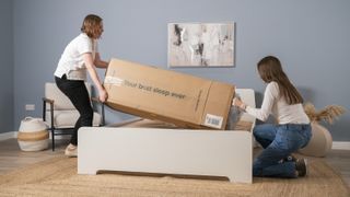 The image shows Tom's Guide's testers unpacking the Siena Memory Foam Mattress