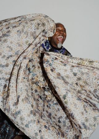 Portrait of Nick Cave with Knoll Textiles fabric design floating in the air