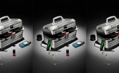 A silver Rimowa vanity case with several beauty products