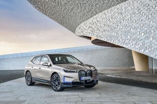 BMW ix in gray parked by a building