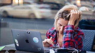 upset woman using a MacBook