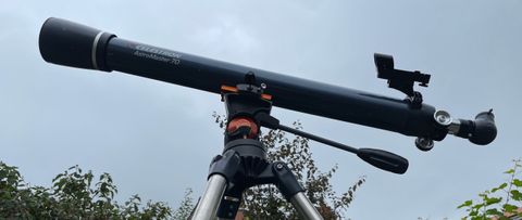 Celestron astromaster 70az telescope profile view against a cloudy sky