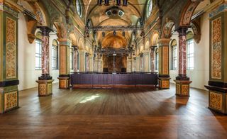 The restored chapel, featuring decorated pillars, domed ceilings and dark wood floor