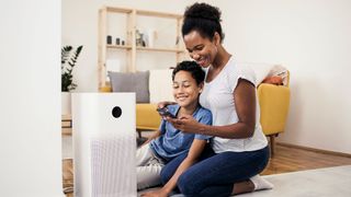 woman and child enjoy air purifier