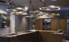 A U shaped island kitchen with circular rings above.