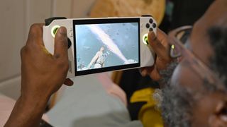 Best Handheld Gaming Devices 2024 - Asus ROG Ally in a man's hand as he plays Star Wars Jedi Survivor