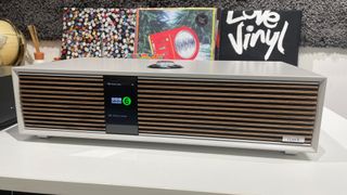 Ruark Audio R410 on a table in front of vinyl albums