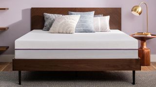 Best cooling mattress: the Purple Mattress placed on a wooden bedframe in a light purple bedroom