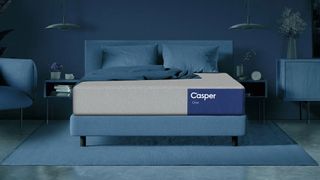 The Casper One Mattress on a blue bed frame in a blue bedroom