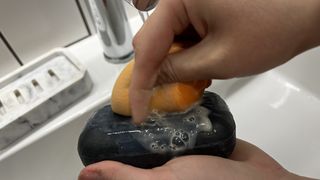 An image showing a person cleaning a Beautyblender