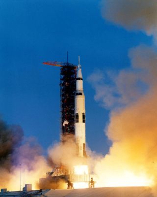 Apollo 13 mission launches to the moon on top of Saturn V rocket.