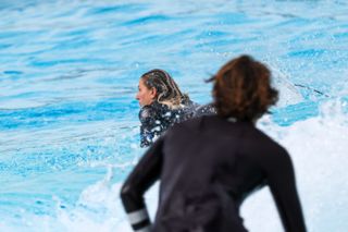 Two surfers in the water at a wave park