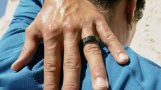 Oura Ring 4 in black on a user's finger