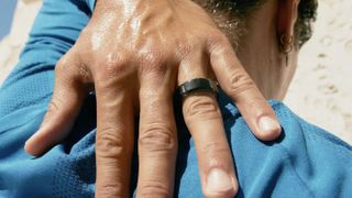 Oura Ring 4 in black on a user's finger