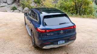 Mercedes EQS SUV parked outdoors in woods