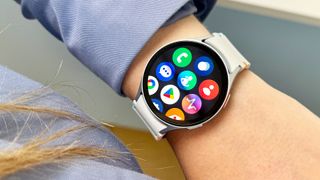 Samsung Galaxy Watch 7 on a person's wrist showing the apps list