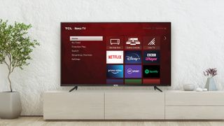 A TV on a stand displaying a Roku operating system interface