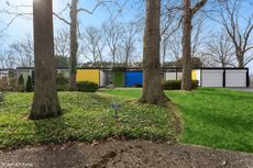 colourful views of michigan's modernist, single storey Frost House with large openings towards nature