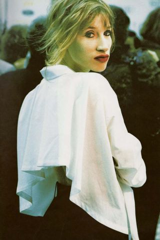 Woman with red lips and heavy black eye liner makeup by Inge Grognard