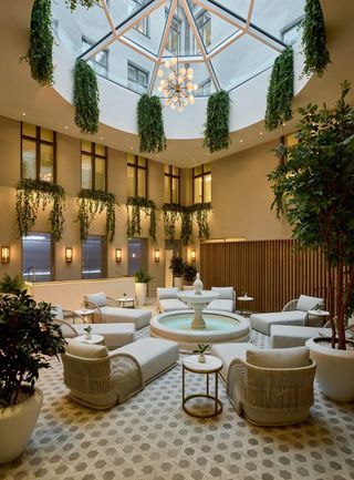 Spa internal courtyard beneath atrium, with daybeds, at The Hotel Maria