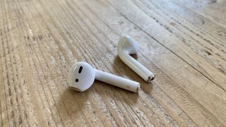 Apple AirPods on a wooden table 