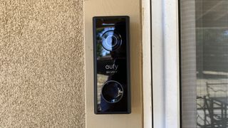 Eufy Video Doorbell 2K mounted beside a door